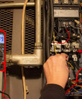 True RMS 6000 Count Digital Multimeter With Low Pass Filter And NCV Detector in use, testing electrical panel voltage