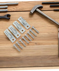 Smooth Operator Four Piece Wall Mount Gate Hinge Set Built For Heavy Duty Barn Doors And No Fuss Fence Post Setup with screws and tools.