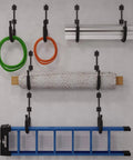 Heavy Duty Kayak Wall Mount Rack With 100 Lb Capacity For Kayaks Paddleboards Surfboards Snowboards And More Garage Storage Space Saver Wall Hanger Keeps Your Gear Neatly Off The Floor, holding various items on a wall.