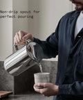 Person using Stainless Steel Electric Kettle With Precision Temperature Control From 104 To 212 F 1200 Milliliters Capacity Double Wall Design