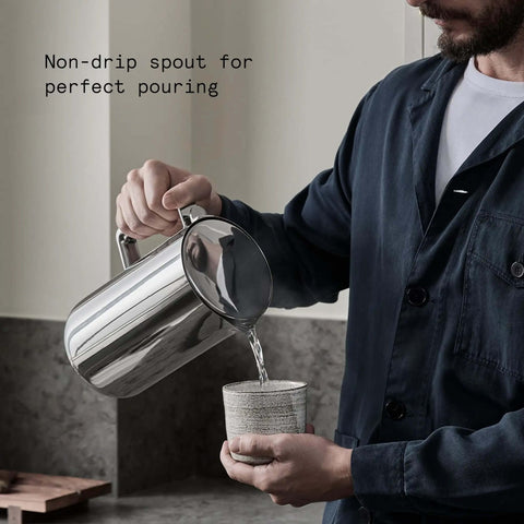 Person using Stainless Steel Electric Kettle With Precision Temperature Control From 104 To 212 F 1200 Milliliters Capacity Double Wall Design