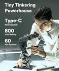 Person using Mini Electric Screwdriver Kit With 56 Bits Three Torque Settings Auto Stop Protection LED Light for fine assembly work.