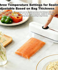 Three In One Handy Handheld Vacuum Sealer for Bags and Jars with food-grade seal packaging salmon, with peppers in background.