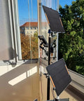 2 Pack USB Solar Panel Kit 6W 5V Monocrystalline Mini Panels With USB 2.0 Port set up on balcony rail under sunlight