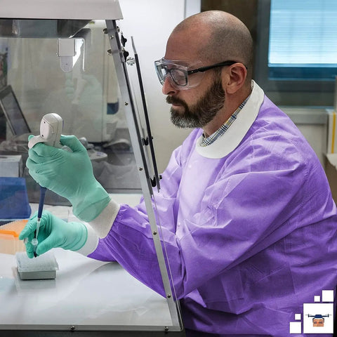 Lab worker in Purple Medium Disposable Lab Jackets Crafted In Lightweight SMS 50 GSM 30 Inch Hip Length With Snap Front Knit Cuffs