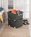 Smooth Rolling Storage Basket With Gray Plastic Mobile Organizer Bin Featuring Four Nifty Pivot Wheels Fold Down Handles For Easy Room To Room Moves Tailored For Keeping Laundry Clothes Toys And Closet Gear Tight And Square filled with sports balls in a bedroom setting.