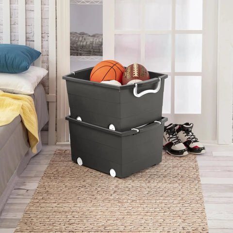 Smooth Rolling Storage Basket With Gray Plastic Mobile Organizer Bin Featuring Four Nifty Pivot Wheels Fold Down Handles For Easy Room To Room Moves Tailored For Keeping Laundry Clothes Toys And Closet Gear Tight And Square filled with sports balls in a bedroom setting.