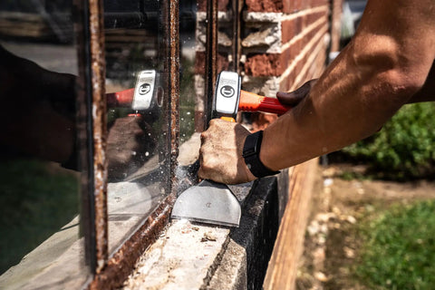 Worker using Brick Chisel 4 Inch By 7 And A Half Inch With Enlarged Striking Cap High Visibility Rawhide Paint on masonry wall