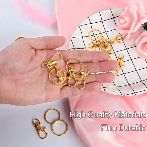 Premium Hella Tough Gold Swivel Snap Hooks With Key Rings 60 Piece Pack in hand, showcasing durable zinc alloy clips and rings.