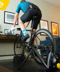 Man using M2 Smart Indoor Bike Trainer With Zwift Compatibility, No-Fuss Wheel On Mount, quiet electromagnetic resistance.