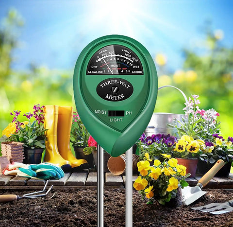 All In One Soil Tester With Moisture Meter, pH And Light For Indoor Outdoor Plants, shown in a garden setting with flowers.