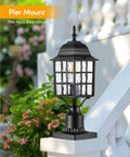 Outdoor Dusk To Dawn Post Light With A 3 Inch Pier Mount Base 19 Inch Tall Exterior Lantern Featuring Tempered Glass Anti Rust Die Cast Aluminum Construction Matte Black Hardwired 120V Lamp Post For Homes And Driveways on railing, surrounded by flowers.