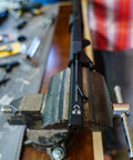 Action Rod Alignment Tool For Gunsmithing, One Piece Aluminum With Steel Contact Design And Locking Mechanism in use on workbench