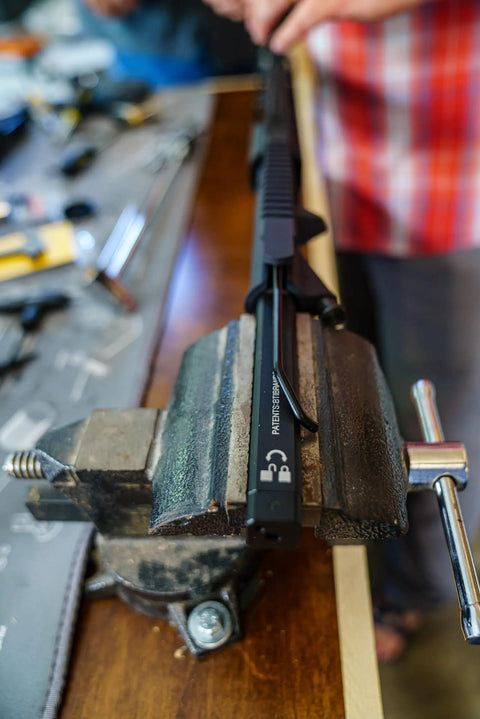 Action Rod Alignment Tool For Gunsmithing, One Piece Aluminum With Steel Contact Design And Locking Mechanism in use on workbench