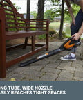 Person using Cordless Leaf Blower For Fast Lawn Cleanup With 120 MPH Air Lightweight Three And A Half Pound Powerhouse Long Nozzle WG5451 under bench