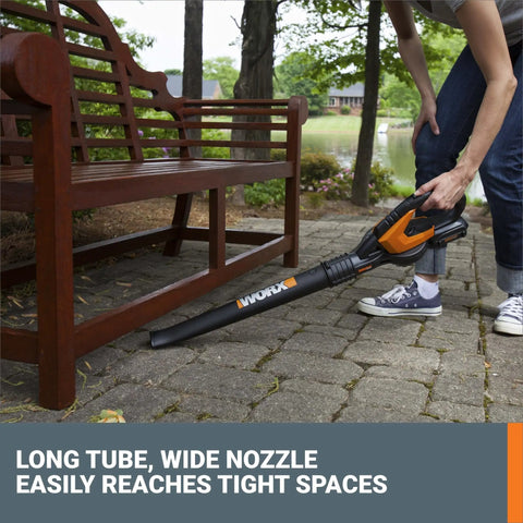 Person using Cordless Leaf Blower For Fast Lawn Cleanup With 120 MPH Air Lightweight Three And A Half Pound Powerhouse Long Nozzle WG5451 under bench
