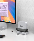 Mac Mini M4 And M4 Pro Stand Hub That Sets Your Workstation On Fire With 40 Gbps Thunderbolt Speed Houses Roomy Nvme Ssd Enclosure Handling Up To Eight Tough Terabytes Alongside Kickass Usb Hookups on desk with monitor.