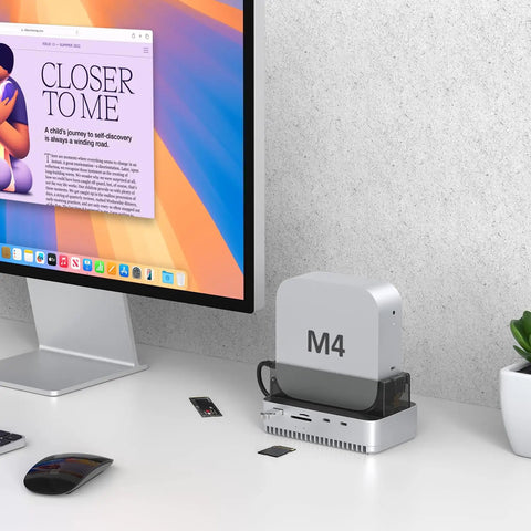 Mac Mini M4 And M4 Pro Stand Hub That Sets Your Workstation On Fire With 40 Gbps Thunderbolt Speed Houses Roomy Nvme Ssd Enclosure Handling Up To Eight Tough Terabytes Alongside Kickass Usb Hookups on desk with monitor.