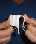 Person holding Mighty Putter Clip Holder for Golf Bag with Dual Ring Mounts, showing durable nylon clip and installation rings.