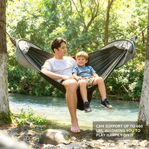 Father and son relaxing in All In One Camping Hammock With Mosquito Net And Rain Fly Tarp by a river