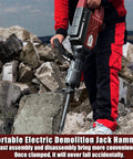 Person using the 1900W Demolition Electric Jack Hammer Heavy Duty Concrete Breaker With Flat Chisel on a rocky surface.