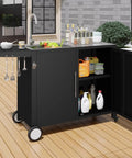 Outdoor Kitchen Sink With Hose Hookup And Stainless Steel Prep Table on wheels, shown on a wooden patio with open storage