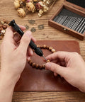 Top Shelf 31 Piece Micro Drill Bit Set With Ergonomic Pin Vise for tiny holes, a person drilling a wooden bead.