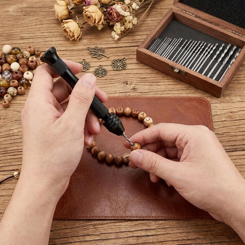 Top Shelf 31 Piece Micro Drill Bit Set With Ergonomic Pin Vise for tiny holes, a person drilling a wooden bead.