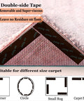 Close-up of non slip rug grippers for hardwood floors pack of 8, showing adhesive side under a pink carpet edge.
