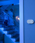 Nighthawk Carbon Monoxide Alarm Battery Operated With Three AA Batteries Installed on wall in dimly lit home