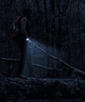 Hiker using 20 In 1 Paracord Survival Bracelet With SOS LED Light Fire Starter Compass Whistle And Thermometer at night