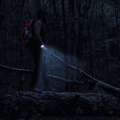 Hiker using 20 In 1 Paracord Survival Bracelet With SOS LED Light Fire Starter Compass Whistle And Thermometer at night