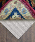 No Slip Full Size Mattress Gripper And Rug Pad Keeps Mattress In Place And Rug From Sliding All Night Long Non Adhesive PVC Foam Anti Slip Pad For Bedroom And Living Room shown under a colorful rug on wooden floor