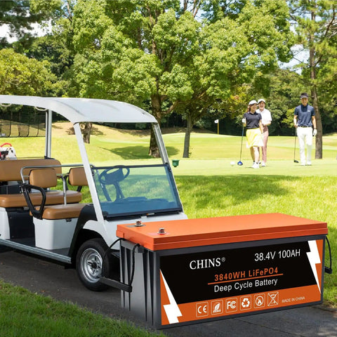 36V Lithium Golf Cart Battery 100Ah LiFePO4 with Built-In Bluetooth 200A BMS beside golf cart on course