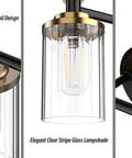 Close-up of Three Light Black Brass Vanity Fixture With Clear Striped Glass Shades E26 Base; antique bronze and black details
