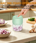 Chill Out With This Tiny Wireless Garlic Chopper That Zips Mini Food Processing, compact mint green garlic mincer in use chopping onions.