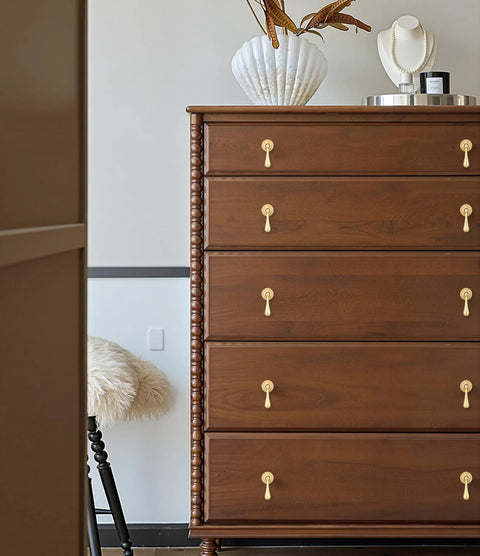 Solid Brass Cabinet Knobs 2 Pack In Brushed Gold Finish installed on a wooden dresser, modern pendant pulls for drawers