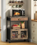 Real Deal Farmhouse Coffee Bar Cabinet And Three Tier Rolling Cart With Loaded Storage Drawer Sturdy Locking Casters Rustic Brown Wood Frame leather trim and a microwave in a kitchen corner.
