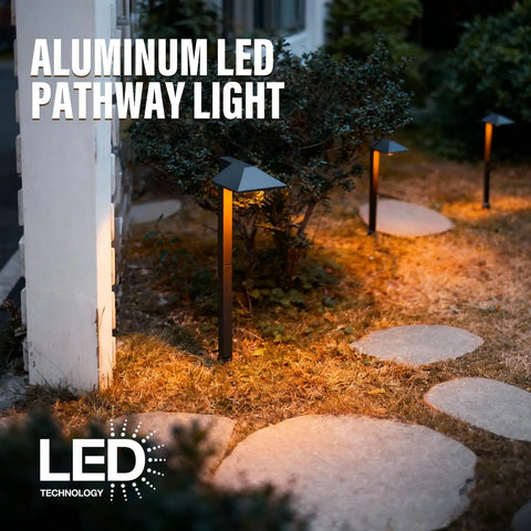 Illuminated yard with 4 Pack 12V Outdoor Landscape Pathway Lighting Kit With 0.6W LED, 3100K Warm White, black aluminum risers at night.