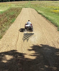 Chain Drag Harrow For ATV And UTV, 5 Foot Wide By 4.5 Foot Long With Half Inch Tines, towed by ATV on dirt road