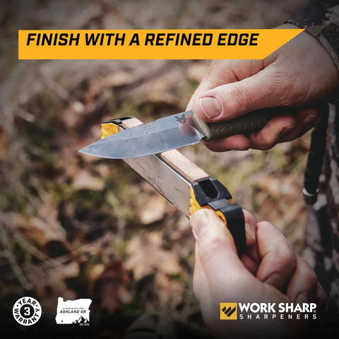 User sharpening a knife with Roam Ready Guided Field Sharpener With Diamond Guides And Adjustable Wrench on a wooden surface.