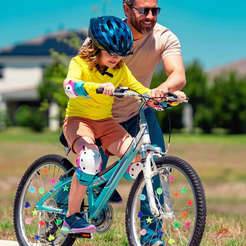 Child riding bike with 210 Glow In The Dark Bike Spoke Beads Set Colorful Plastic Spoke Clips For Bicycle Wheels Assorted Color Decorations