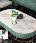 White Gold Marble Peel And Stick Contact Paper on oval coffee table with blue and yellow flowers and magazines