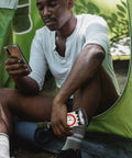 Person in a tent using Outdoor Navigation Compass With Ruler And Mirror, High Precision Mini Hiking Compass For Orienteering