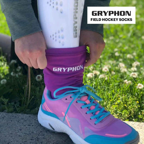 Athlete adjusting Footless Shinguard Socks For Field Hockey And Soccer Athletes With Breathable Comfort, purple socks and shoe