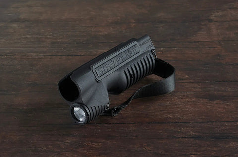 Integrated Tactical Forend Weapon Light For Mossberg Shockwave 12 Gauge With Six And Three Quarters Inch Action Slide, 1000 Lumen, 20000 Candela, Ambidextrous Controls, Strap Included, Black on wooden surface