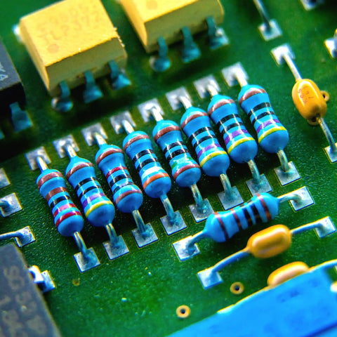 Close-up of a PCB with 1/4W Metal Film Resistor Assortment Kit With Fifty Values From 0 Ohm To 10 M Ohm, One Percent Tolerance, Common Fixed Resistors
