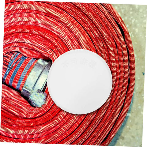 Four Pack Concealed Sprinkler Head Decorative Covers Heavy Duty Iron Protective Plates Built Tough For Outdoor Lawn Irrigation Systems on red garden hose.