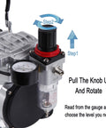 Close-up of airbrush kit with compressor AS18-2K showing pressure regulator with gauge and instructions for adjusting pressure.