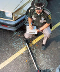 Built Like A Tank Four Inch Dual Measuring Wheel With Sturdy Telescoping Shaft And Five Digit Counter Counts Up To Ten Thousand Feet For Contractors Running Around All Day Long beside a police officer measuring accident scene.
